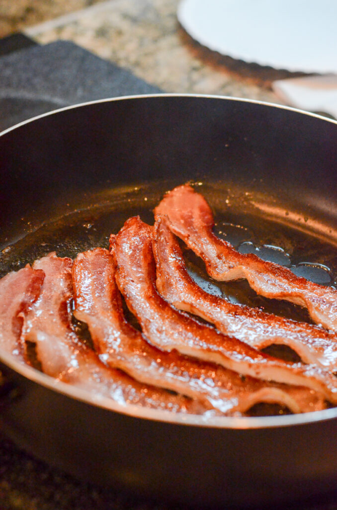 bacon frying in skillet