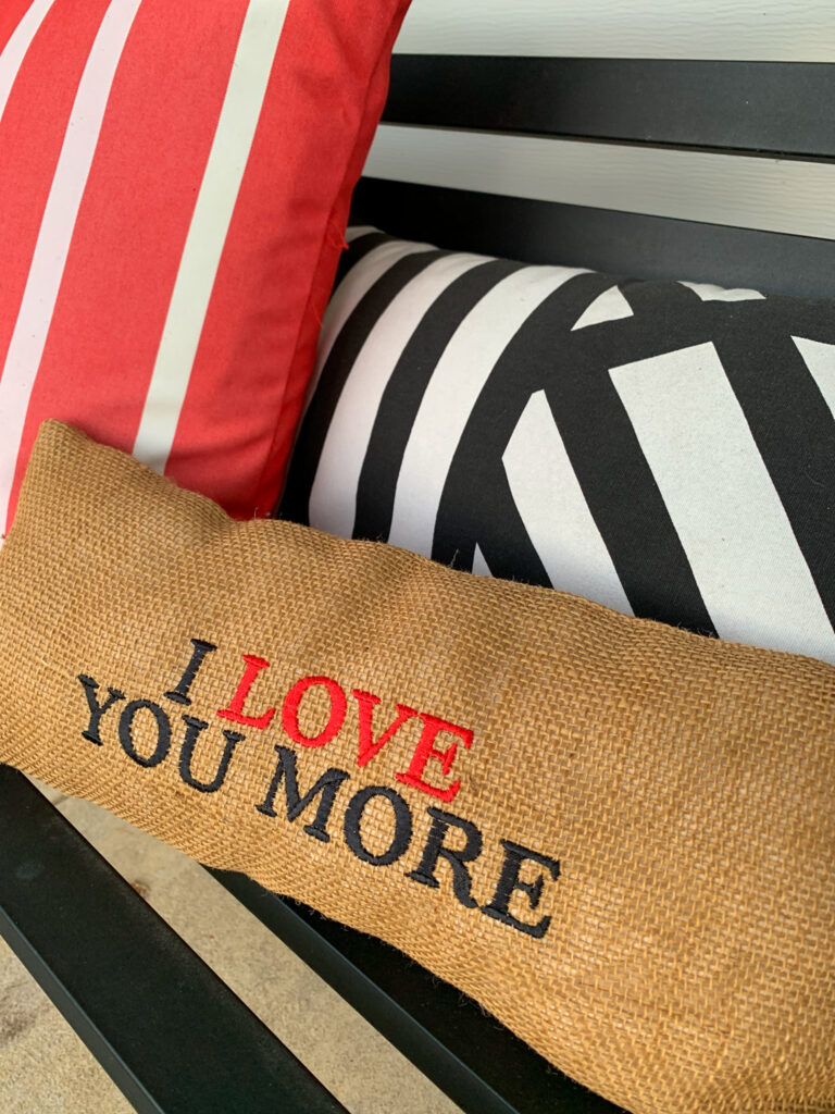 I love you more pillow on porch bench for simple Valentine's Day porch decor