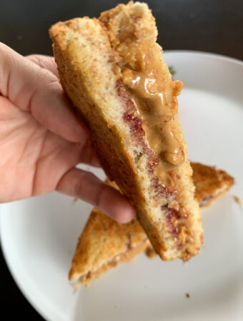 air fryer peanut butter and jelly sandwich in someone's hand