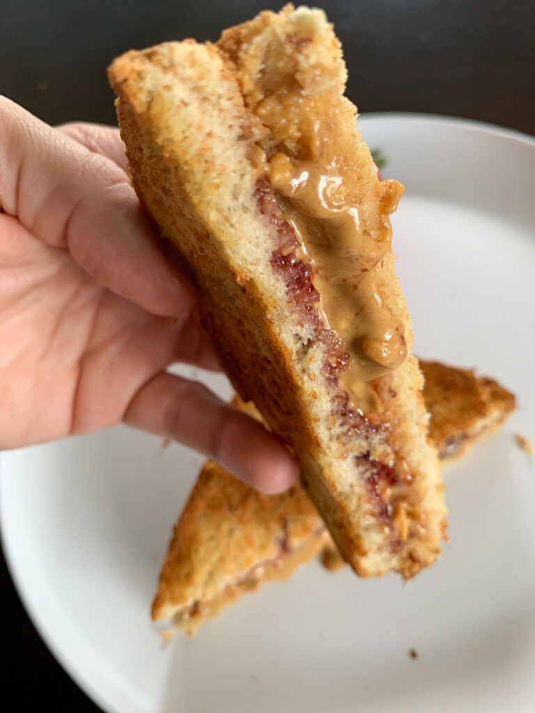 warm air fryer peanut butter and jelly in woman's hand
