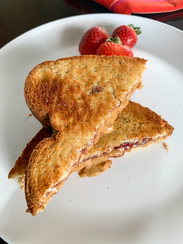 air fried pb&j on white plate with strawberries