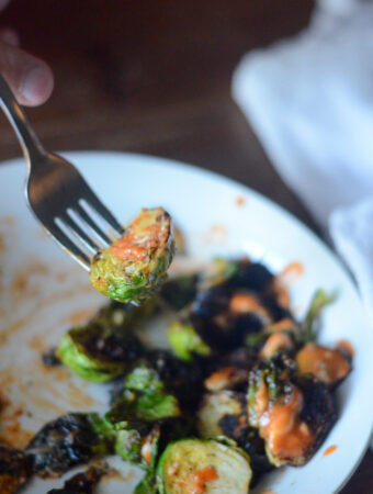 copycat BJs Brussels sprouts with honey sriracha sauce on fork