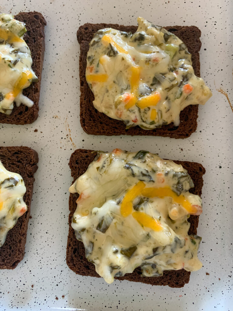 spinach dip on rye bread appetizers on white tray