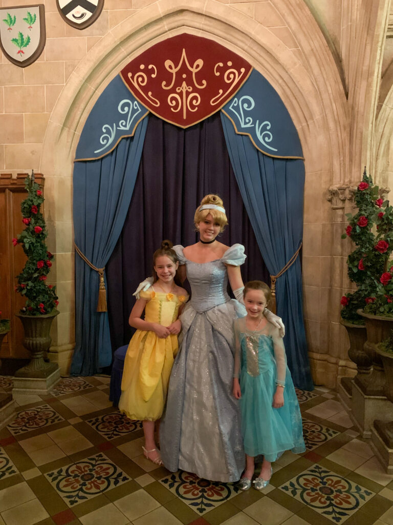 children with Cinderella at Disney World's Cinderella Royal Table restaurant in the castle