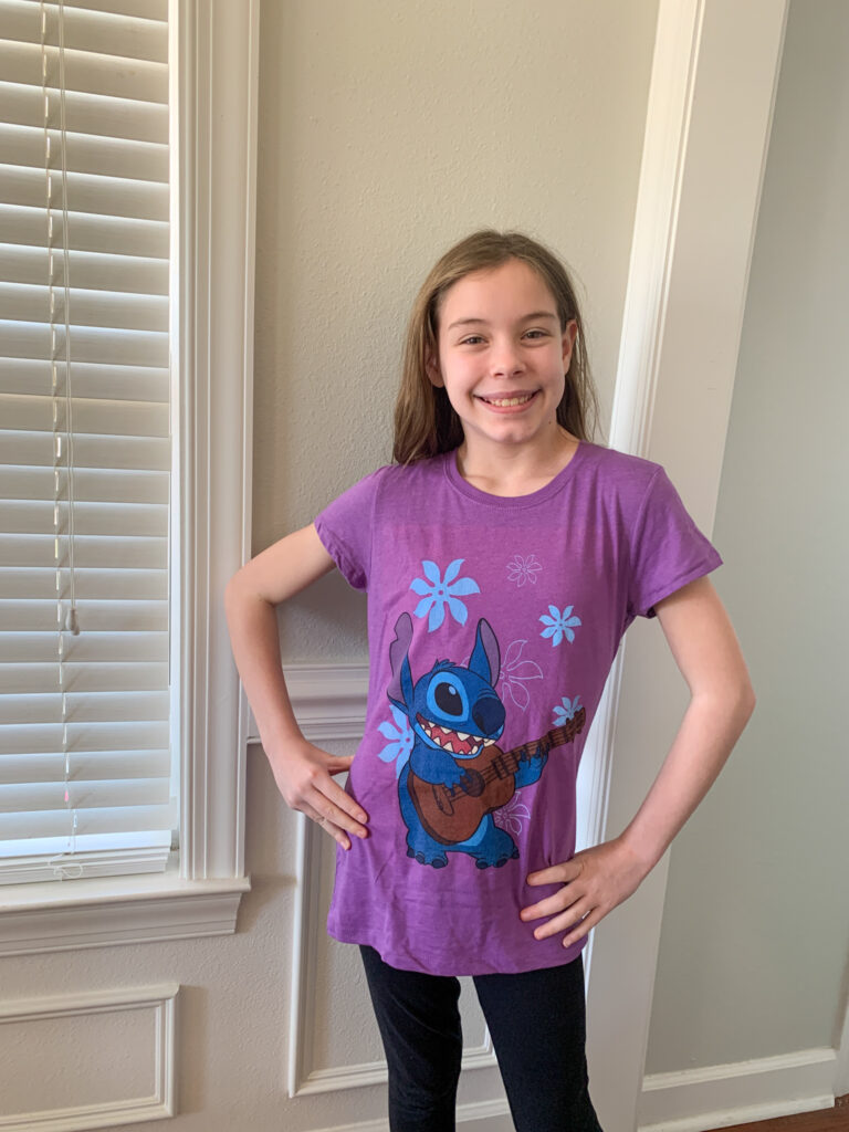 girl wears purple Stitch t-shirt
