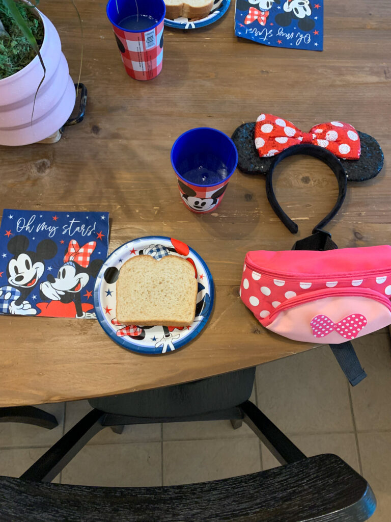 a Mickey Mouse table setting set on kitchen table for a surprise Disney World trip reveal for kids