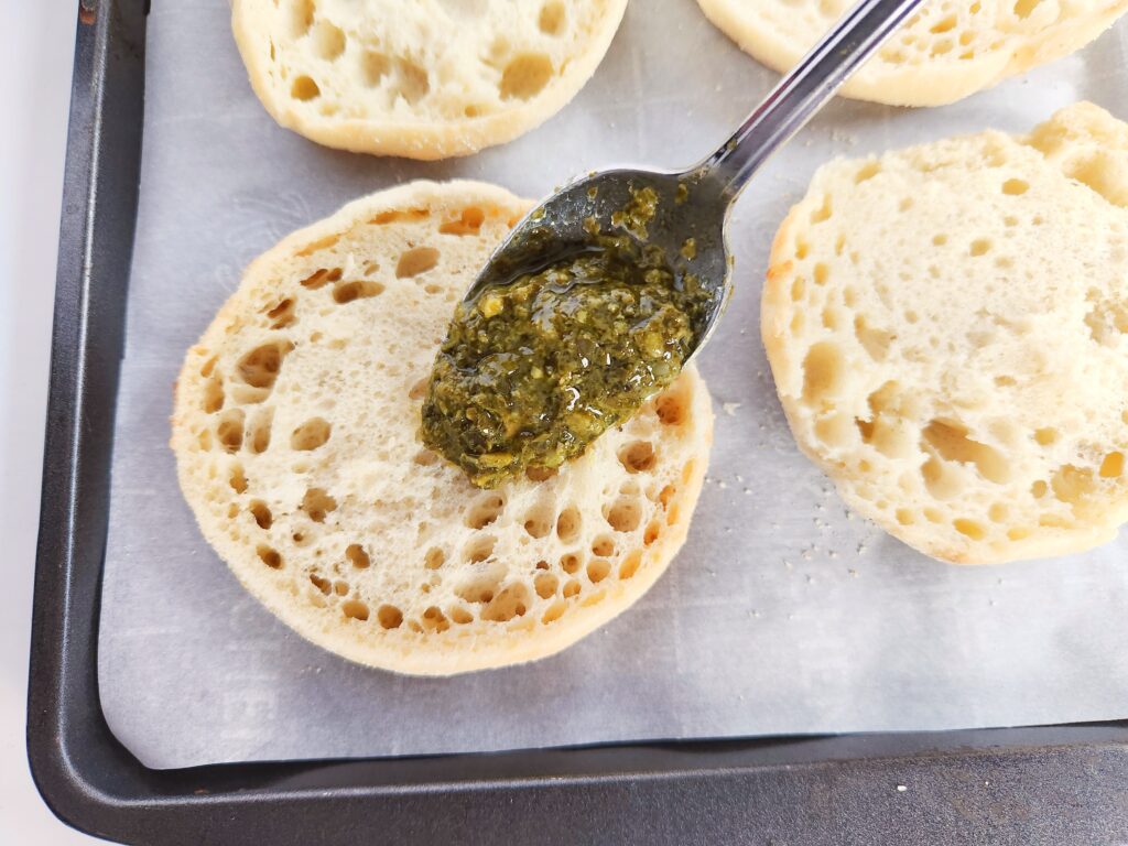 pesto going on top of English muffin
