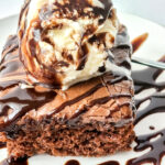 copycat Cracker Barrel Coca Cola cake with ice cream and syrup on a white plate