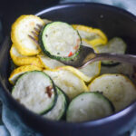 bowl of air fryer zucchini and squash with a fork in the middle