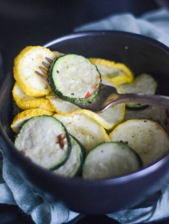 bowl of air fryer zucchini and squash with a fork in the middle