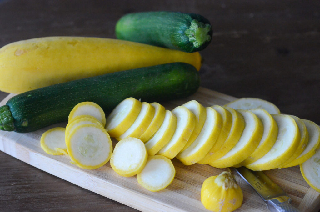 yellow and green vegetables on cutting board with knife