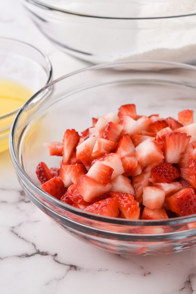 glass bowl of chopped strawberries