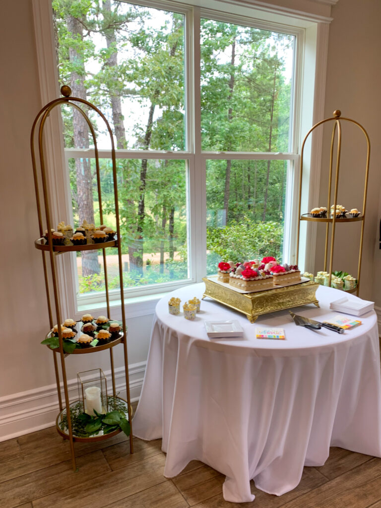 cake table with side shelves of petit fours at a fancy tea party for high school graduation
