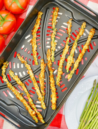 overhead shot of air fryer asparagus fries on air fryer tray