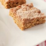 two cinnamon churro bars on white platter