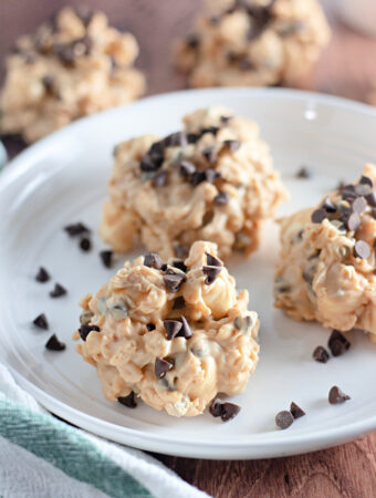 no bake avalanche cookies on white plate with chocolate chips - also known as no bake peanut butter Rice Krispie cookies
