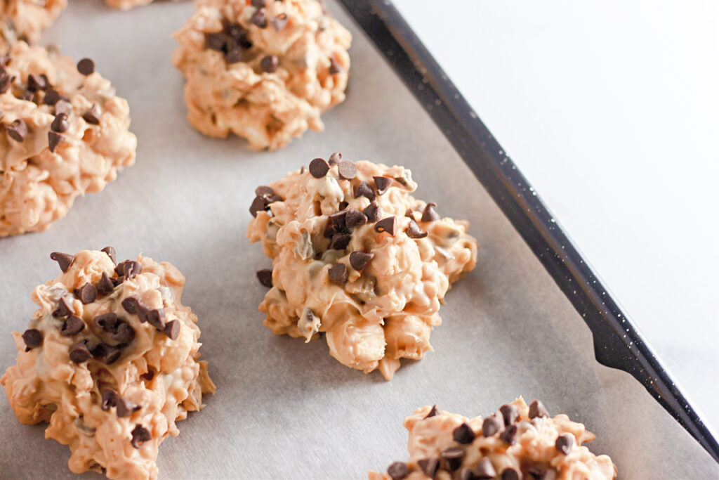 no bake peanut butter Rice Krispie cookies - avalanche cookies - on a baking sheet with parchment paper