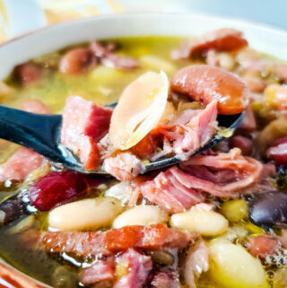 15 bean soup with ham in bowl and black spoon