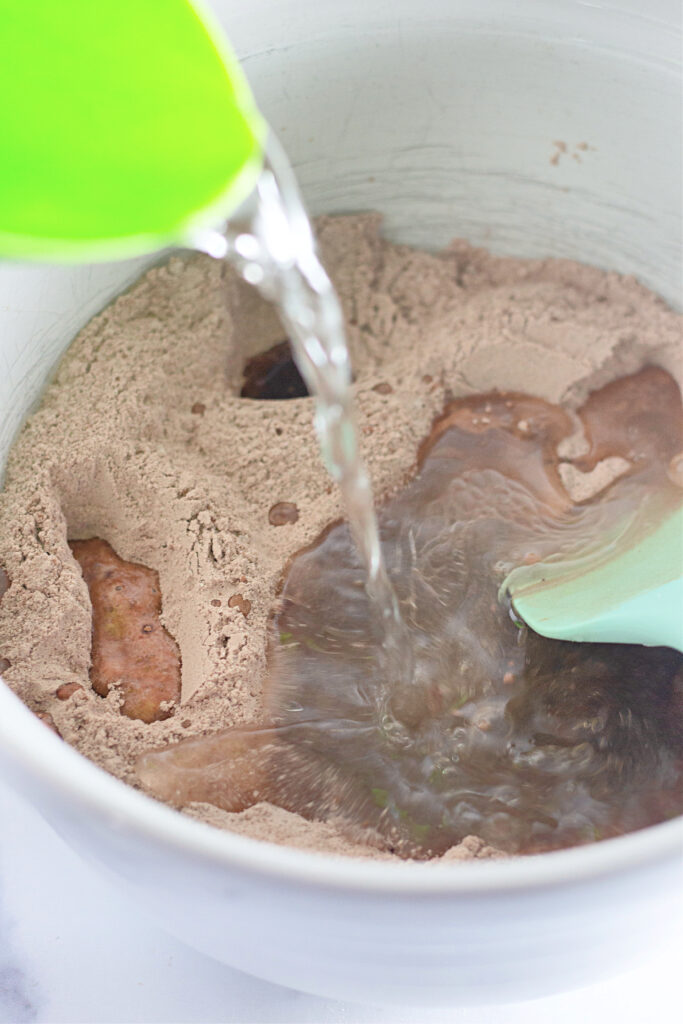 water pouring flour mixture in bowl