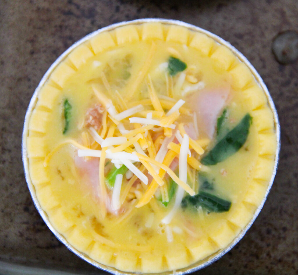 unbaked spinach and ham quiche in a tin shell 