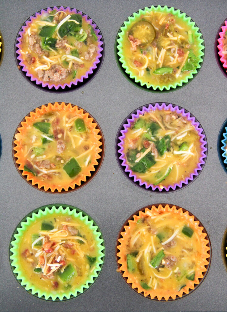 mini crustless quiche muffins with spinach and bacon in colorful silicone muffin cups