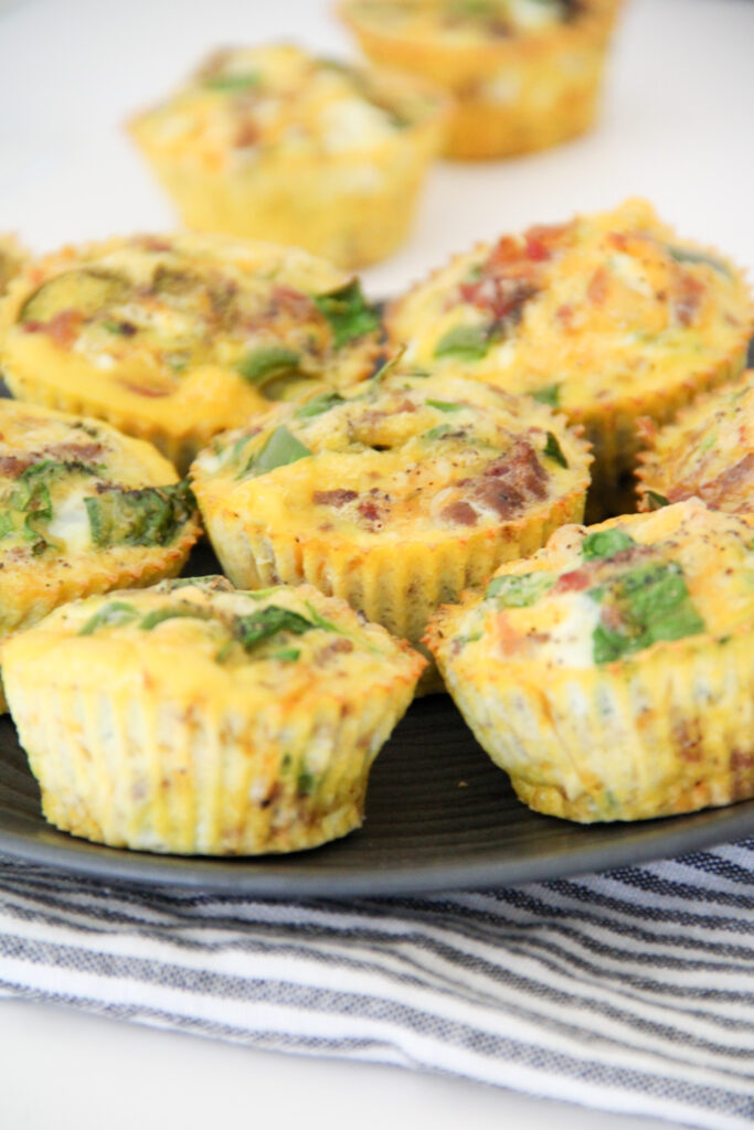 keto crustless quiche muffins in a stack on plate