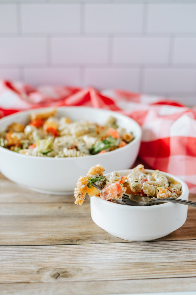 bacon cheddar pasta salad with ranch in white bowls
