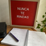 red letter board with inspirational quotes in Spanish and paper calendar in front of it