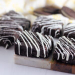 white chocolate Oreo bars with yellow napkin in back