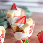 strawberry shortcake cups on wooden table with strawberries