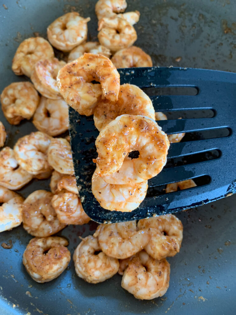 garlic butter shrimp on spatula