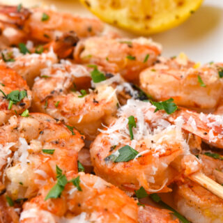 marinaded shrimp skewers on a white tray
