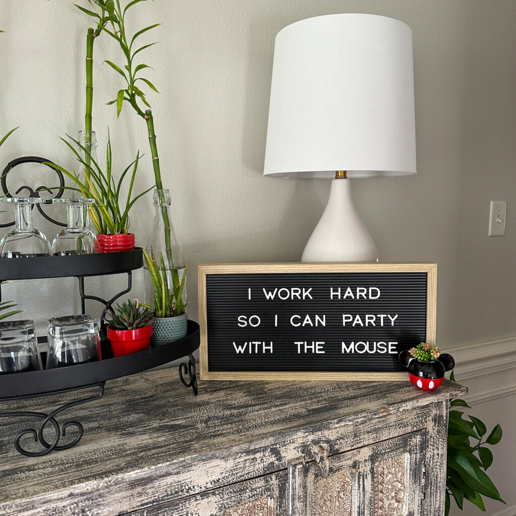 Mickey Mouse and Minnie Mouse quotes on black letter board with small Mickey Mouse planter and lamp