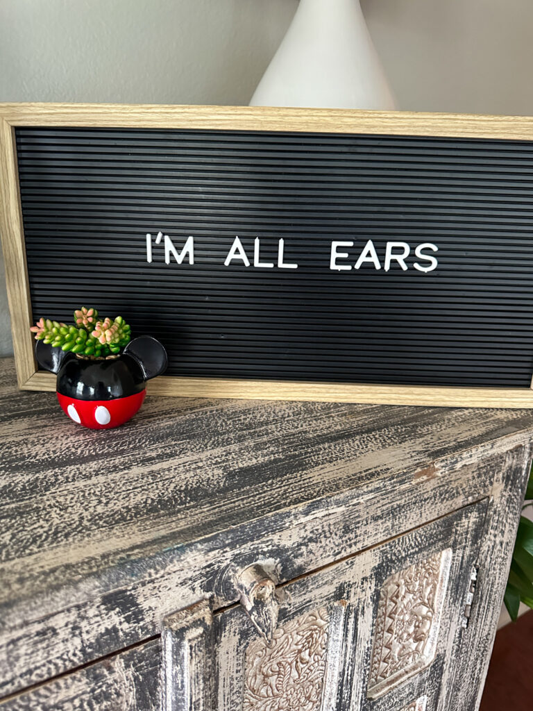 Mickey and Minnie Mouse quotes on letter board with small Mickey planter in front