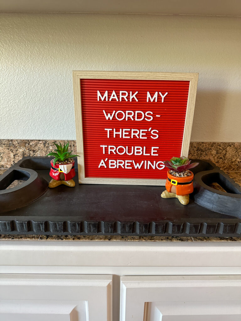 short quotes about Disney World on letter board with Snow White and the Seven Dwarfs planters in front