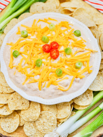 sour cream taco seasoning dip - TikTok boat dip - in white platter surrounded by chips and onion