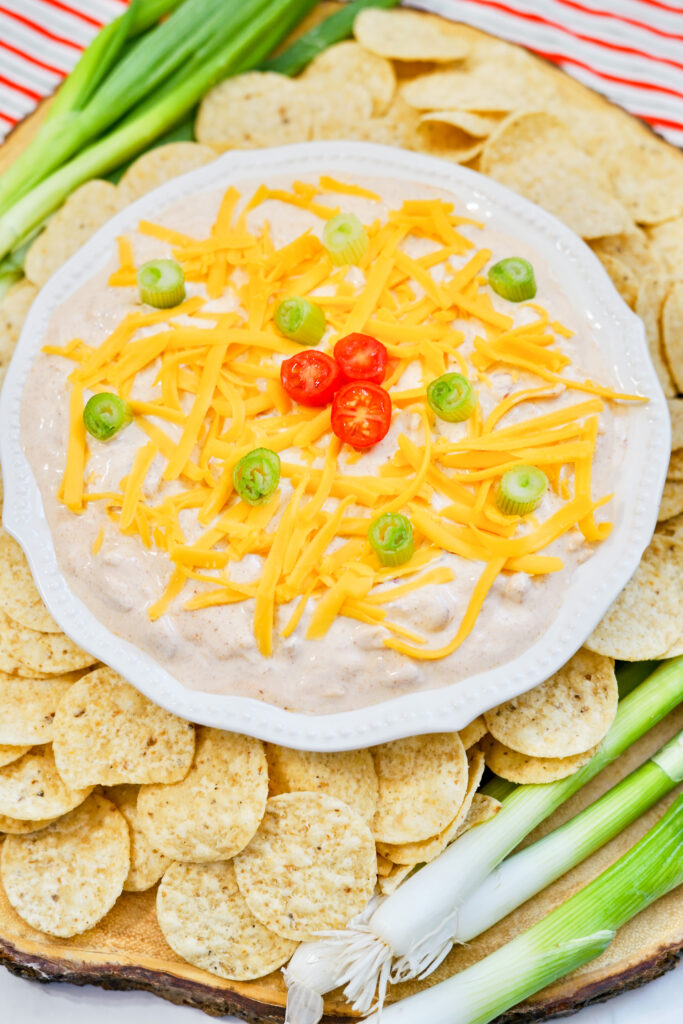 sour cream taco seasoning dip in white bowl with chips around