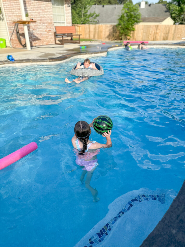 children playing with original Watermelon ball in the pool 