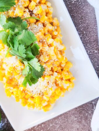 Mexican elote casserole on a white serving platter