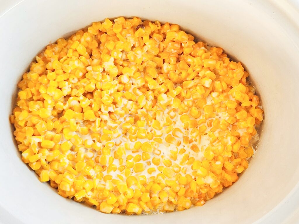 Crock Pot Mexican street corn (Crock Post elote casserole) in a white slow cooker 