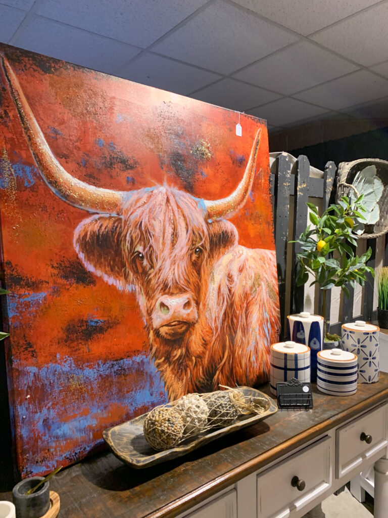 a cow artwork display at a fall Bella Rustina Vintage Market in Little Rock, Arkansas