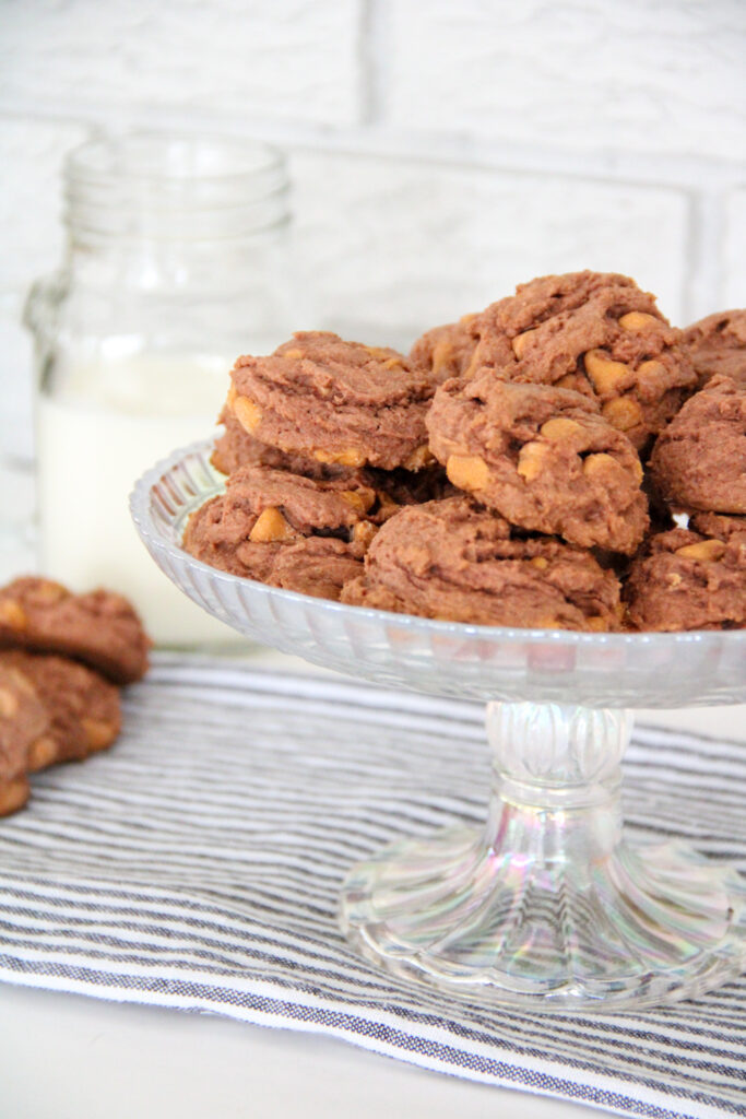 stack of butterscotch chocolate pudding cookies in a glass serving dish