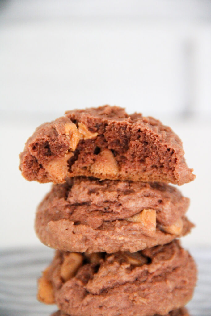 butterscotch chocolate pudding cookies stacked with top one missing a bite