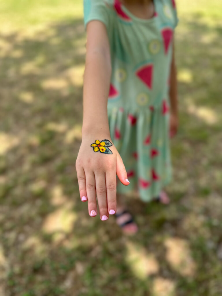 little girl's hand with face painting (hand painting) for company picnic ideas