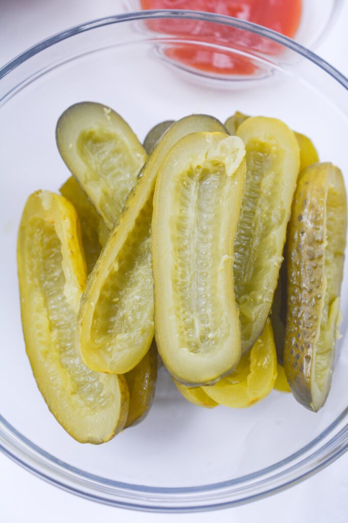 hollowed out pickles in a glass bowl