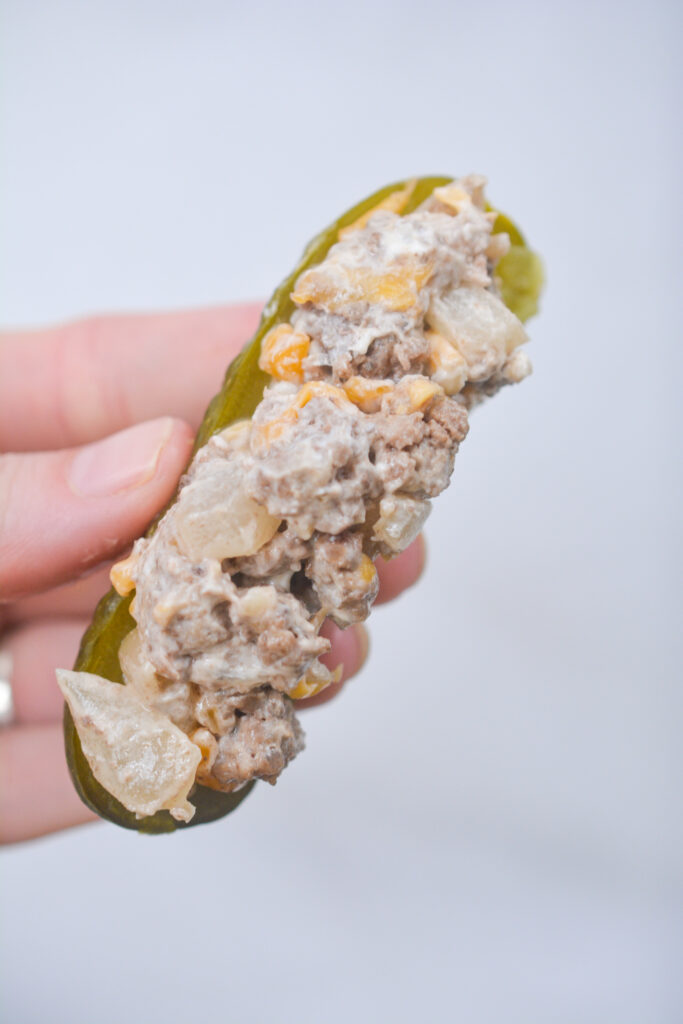 a hollowed out pickle with cream cheese filling inside
