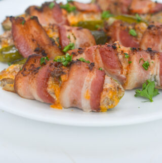 bacon wrapped pickle poppers on a white platter