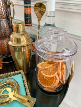 fall bar cart ideas with dehydrated oranges for cocktails on top shelf