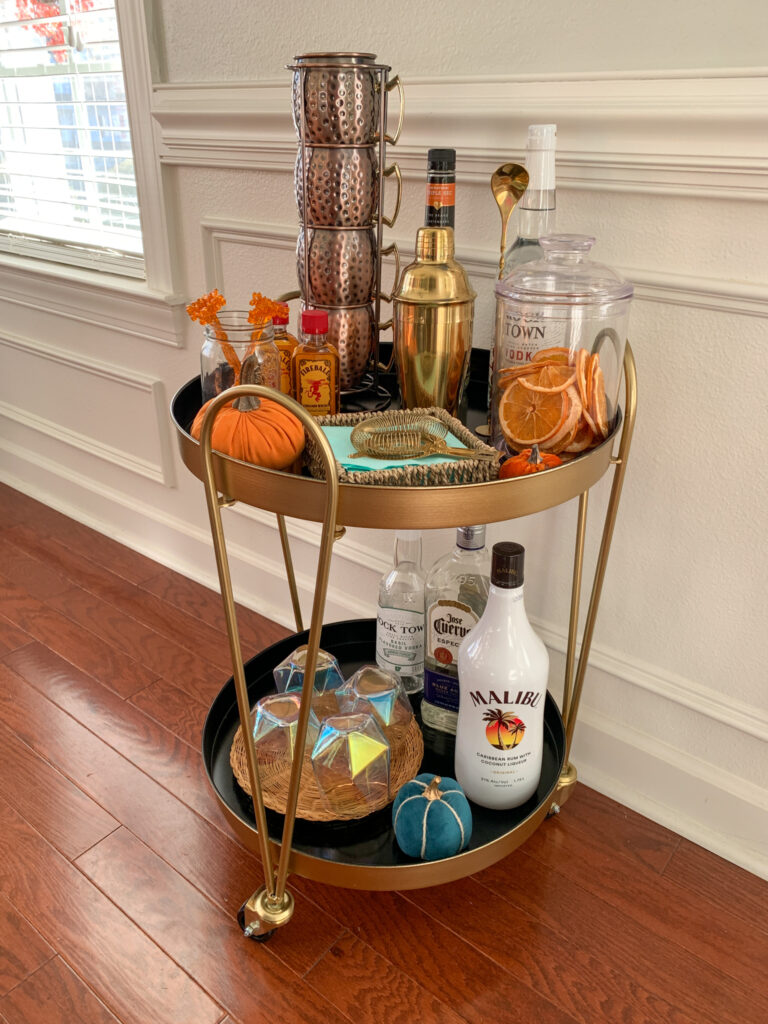 fall bar cart ideas on a small round gold drink trolley