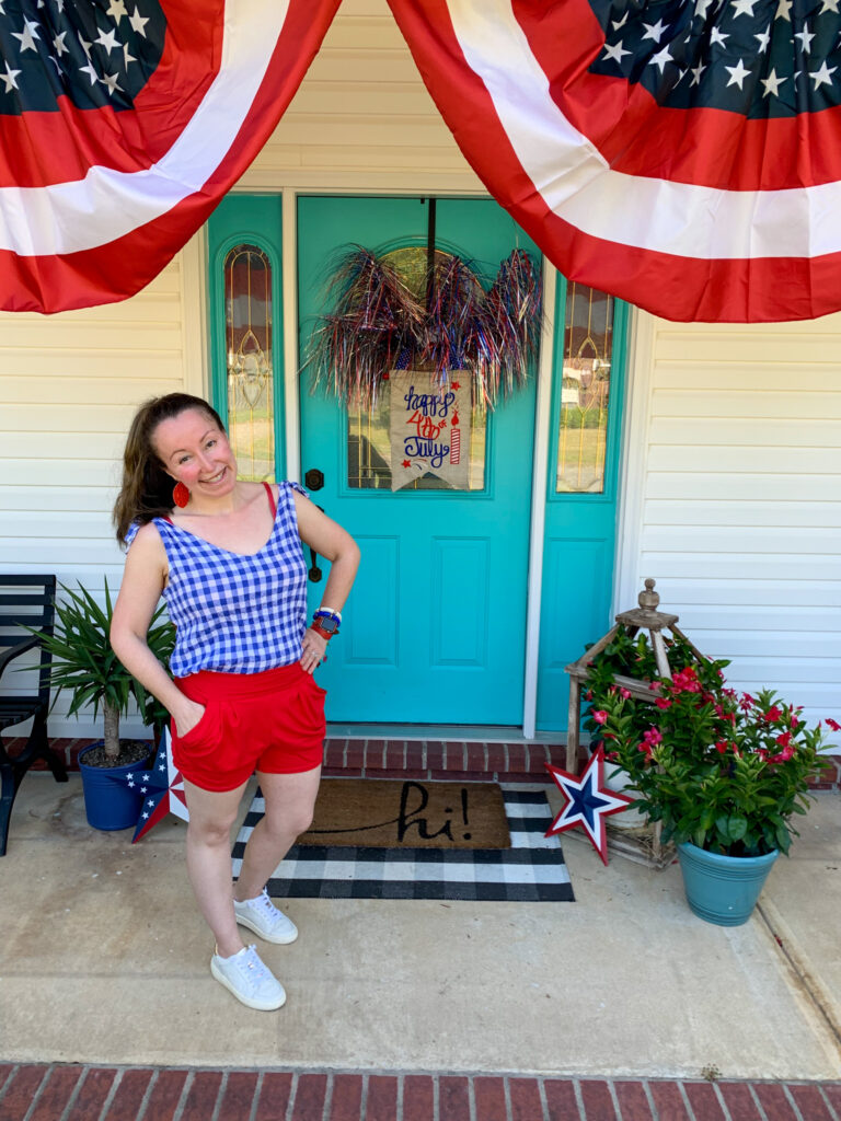 woman wears patriotic outfits on patriotic doorstep